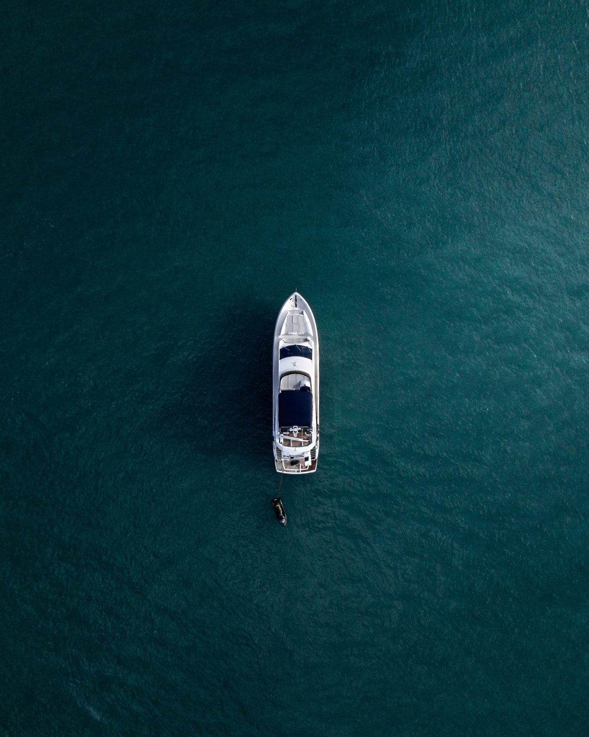 Yacht from above on deep blue water